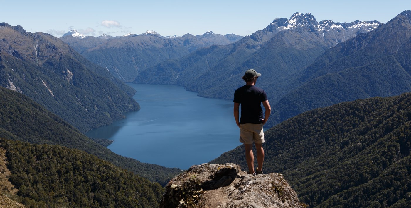 Standing on a summit overlooking a fjord in New Zealand