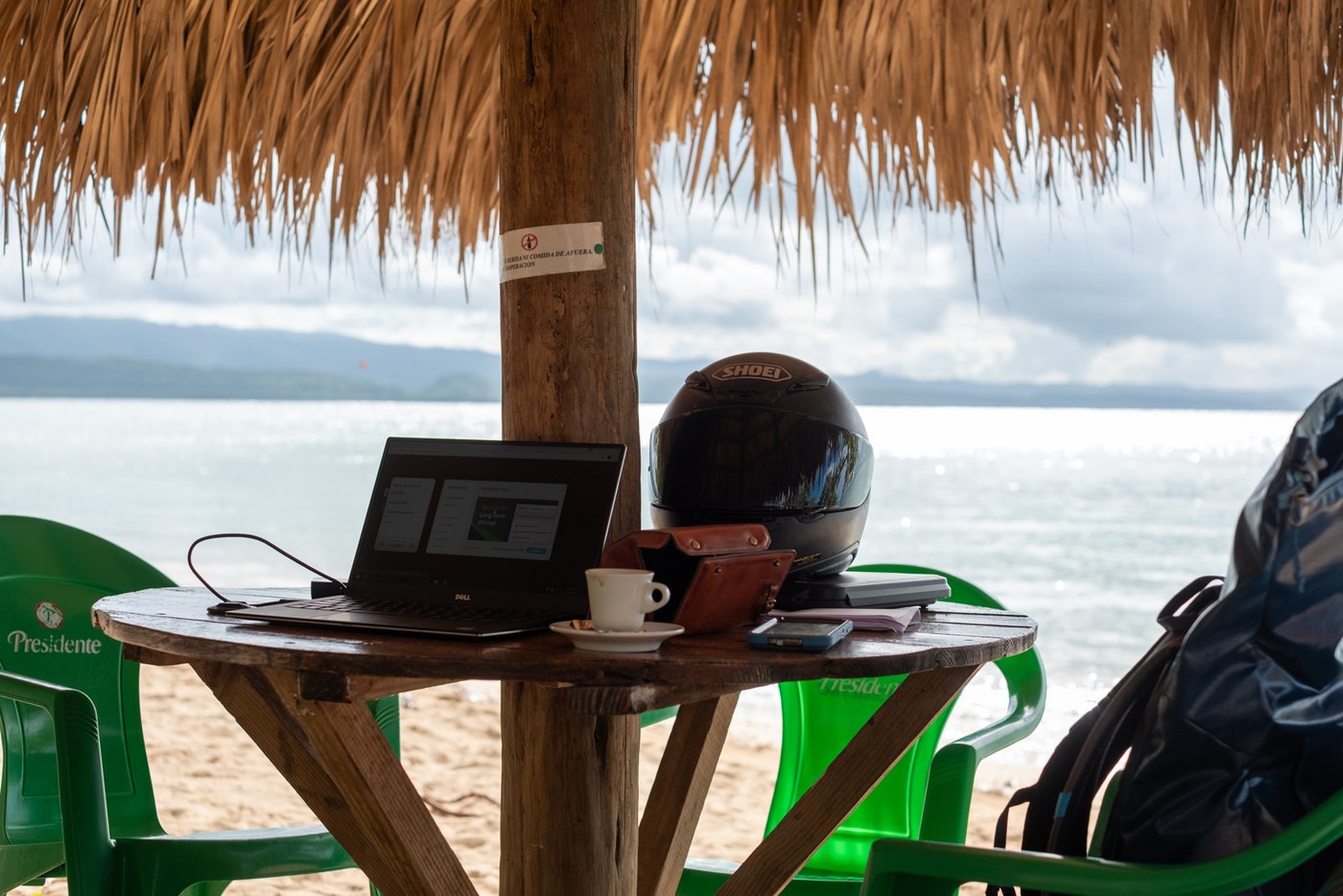 Laptop and espresso at a beach palapa in the Dominican Republic — office for the day